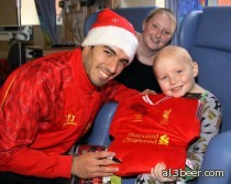 He's not all bad! Suarez dishes out gifts to ill children